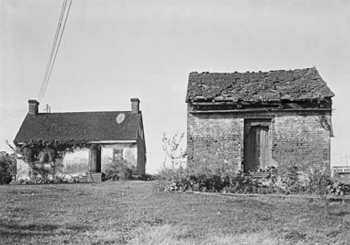 Slave quarters and a wood house are situated on the grounds of an estate in Maryland.  Courtesy of Library of Congress - taken by E. H. Pickering