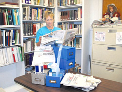 Singletary Librarian Amy Derrington collects 60 years of microfilm from the Cherokeean Herald. The library received a grant to place the back issues on the web. Photo by Earline Bailes.