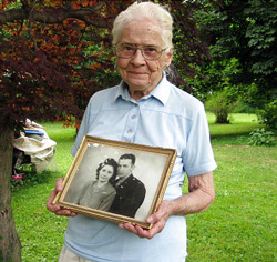 Jean Stevens, 91, holds a photograph from the 1940s of herself and her late husband, James, outside her home in Wyalusing, Pa. Authorities say Stevens stored the bodies of her husband, who died in 1999, and her twin, who died in October 2009, on her property. Michael Rubinkam, AP