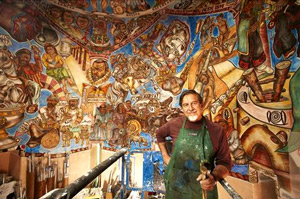 Santa Fe artist Frederico Vigil in front of his latest fresco.