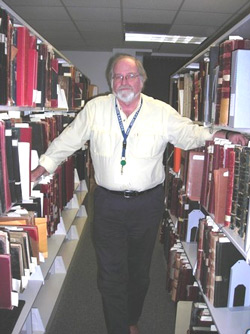 Archdiocese of Boston Archivist Robert Johnson-Lally among records at the Pastoral Center in Braintree.   Photo Credit: Nancy Maloof