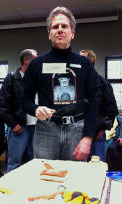 Al Smitley cuts into the cake at his retirement party last Friday.  Photo Credit Steve Fecht