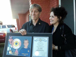 Guitarist Gerry McGee and his wife, Deedee, pose with the plaque McGee received upon his 2011 induction into the Louisiana Music Hall of Fame. / Gannett Louisiana