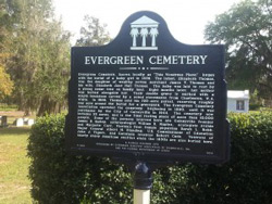 This state historical marker tells what notable people are buried in the Evergreen Cemetery. The site holds about 10,000 graves. Lawrence Chan / WUFT