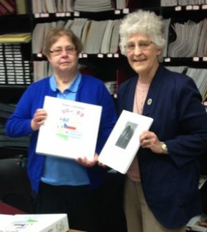 Sr. Cecilia Fandel presents books of her family history to Sue Grosshuesch, Kewaunee Public Library Director.