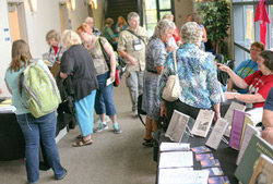 Attendees of the inaugural 2014 Northwest Genealogy Conference talk to various vendors that were at the event.