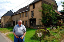 Carl Tiedt standing in front of the home his great-grandparents owned in Bergen, Germany, before they emigrated to America in 1883. He doesn’t know why they left.