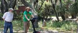 In this undated image provided by Amanda Thompson with the University of Georgia shows archeologists Chester DePratter, left, with the University of South Carolina and Victor Thompson, right, of the University of Georgia, running ground penetrating radar across a land grid. (Amanda Thompson/University of Georgia via AP)