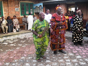 William Holland, a genealogical researcher from Atlanta, dances to the left of Fon Angwafo III, the king of the Mankon tribal group in Cameroon, during a ceremony. Courtesy of William Holland