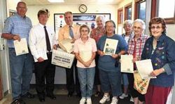 Mailing pamphlets for the Stark County family history book were from left, Don Schmidt, Duane and Doug Sikes, Margaret Cantwell, Sharon Perkins, Dixie King, Margaret Ann Blakey, Janet Turnbull and Betty Sullivan.